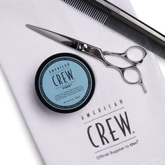 American Crew hair fiber rubbed between hands demonstrating application and easy distribution for flexible hold