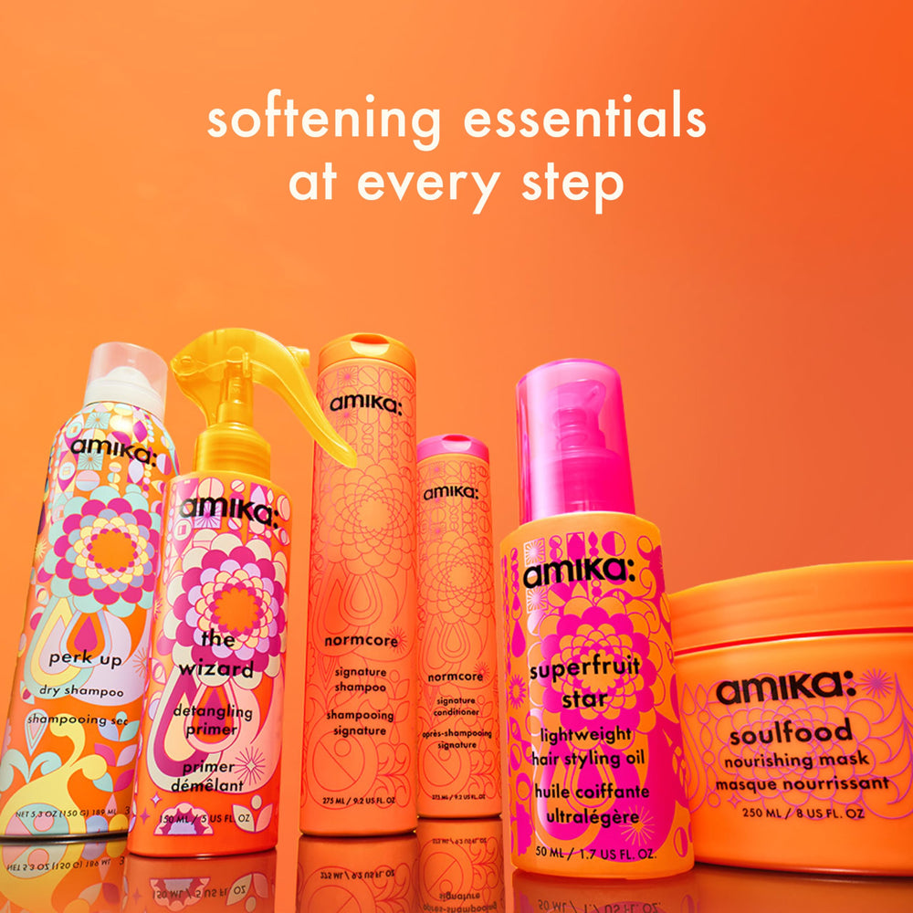amika bottle held in hand showing 275ml size and travel-friendly scale