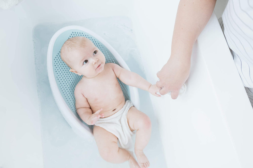 Angelcare rinser in use rinsing baby doll hair reducing splash and worry
