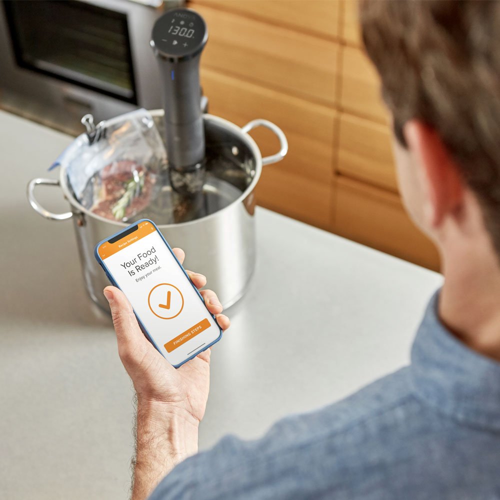 Anova Culinary Nano 2.0 clamped to pot in kitchen, demonstrating hands‑free sous vide convenience