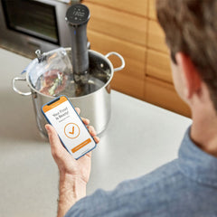 Anova Culinary Nano 2.0 clamped to pot in kitchen, demonstrating hands‑free sous vide convenience