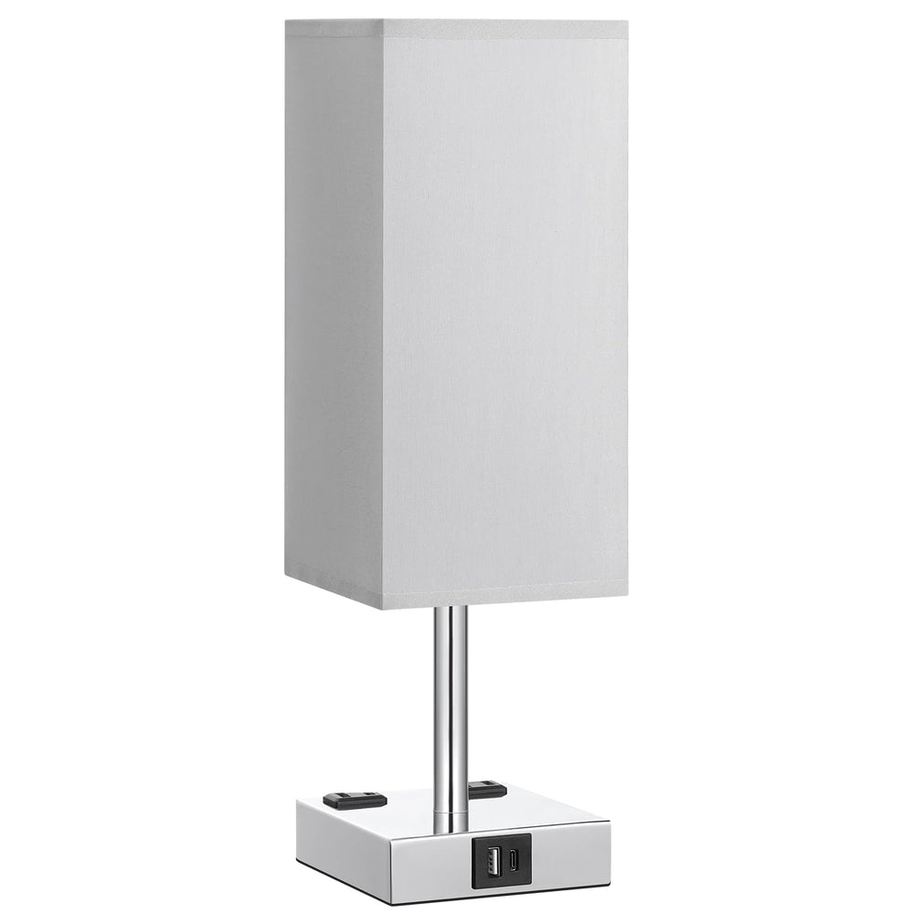 aooshine lamp next to book and phone to show compact scale and bedside fit