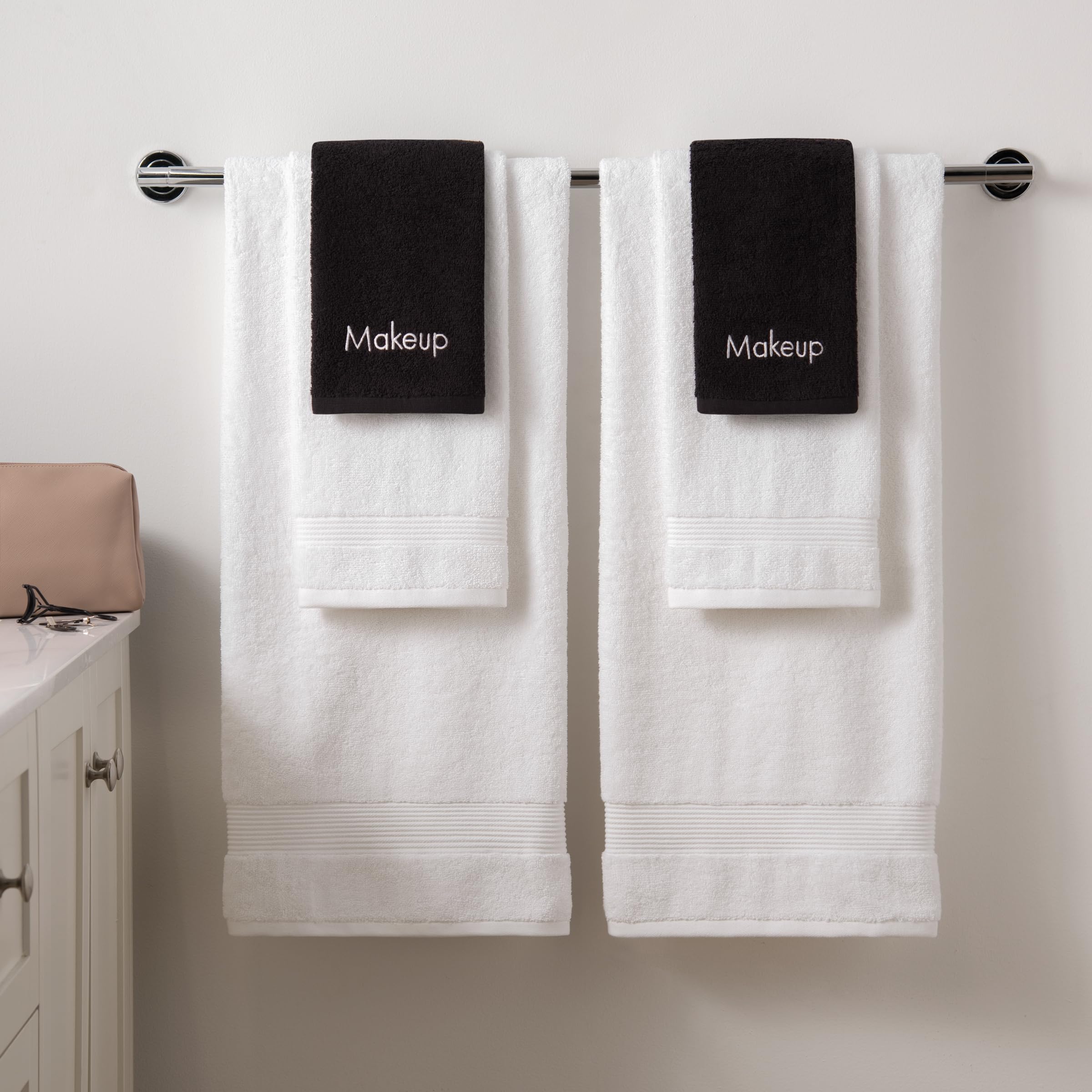 Arkwright LLC towels arranged on vanity next to skincare for aesthetic bathroom organization benefit