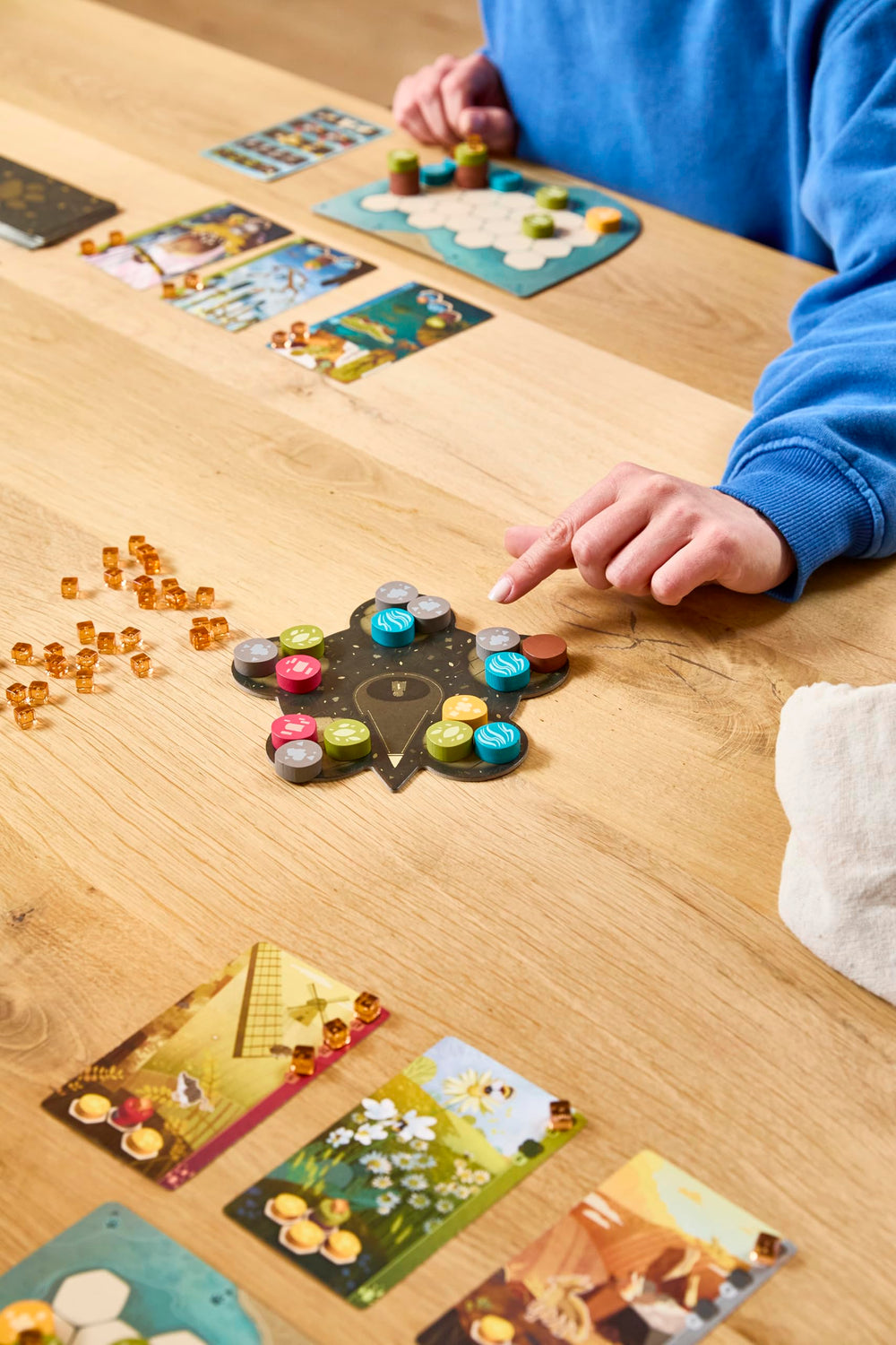 Asmodee game scale with hand showing component size and portability