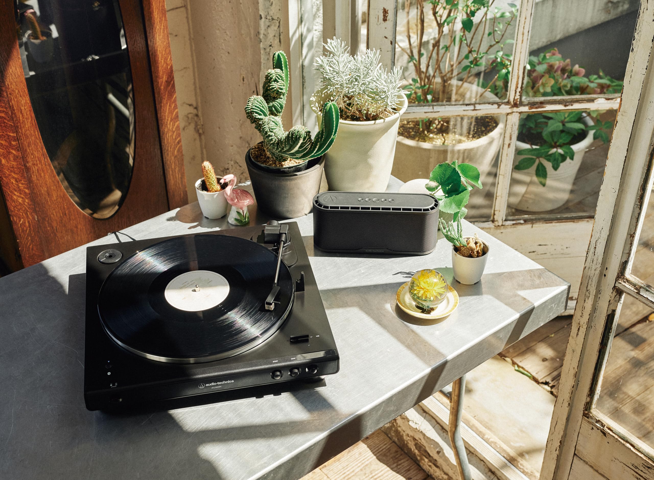 Audio-Technica beside a vinyl sleeve showing scale and portability for small spaces