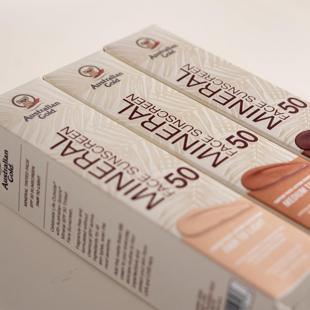 Eucalyptus and red algae props next to Australian Gold tube illustrating antioxidant and blue-light defense benefit