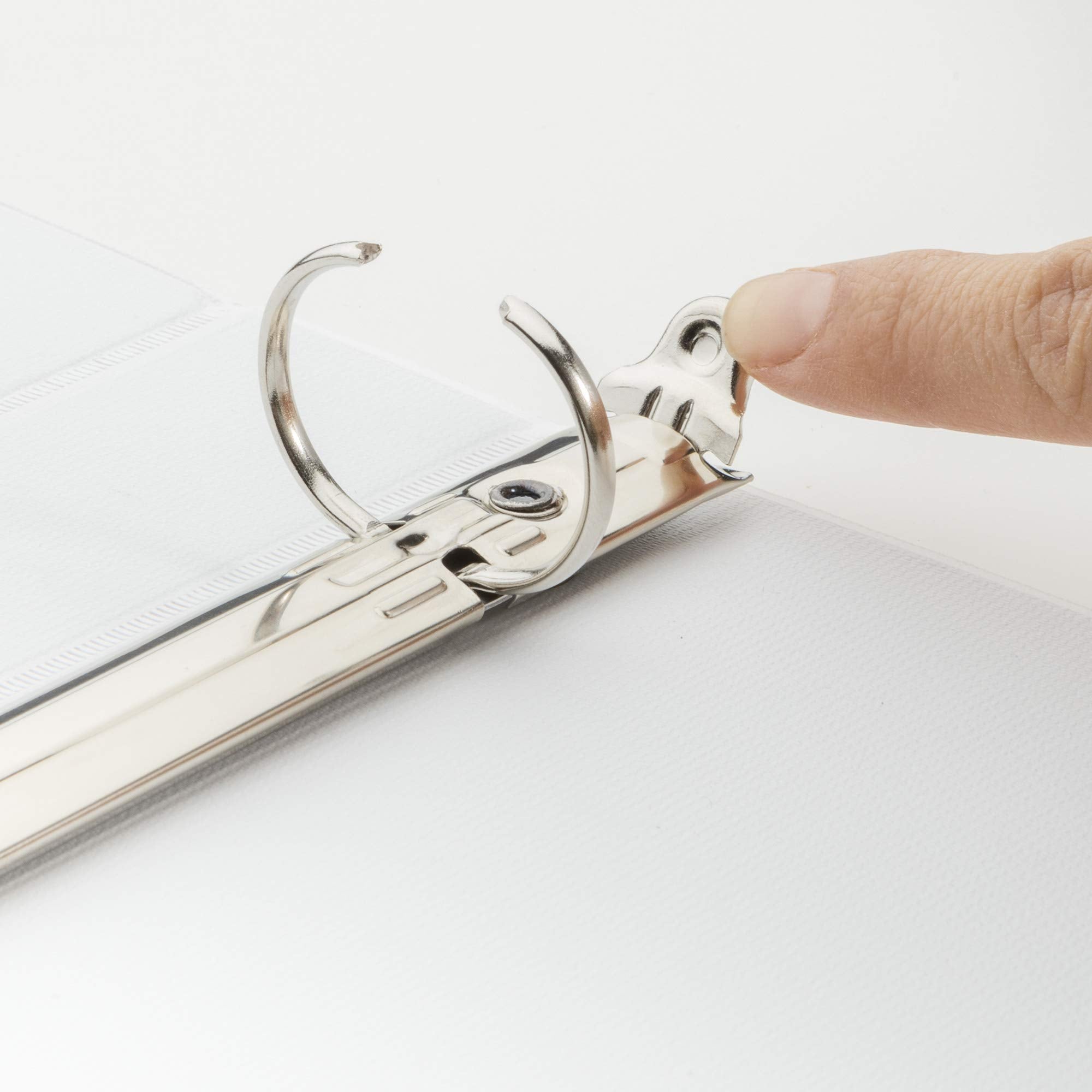 Avery binder next to notebook to show 1.4-inch spine scale and portability