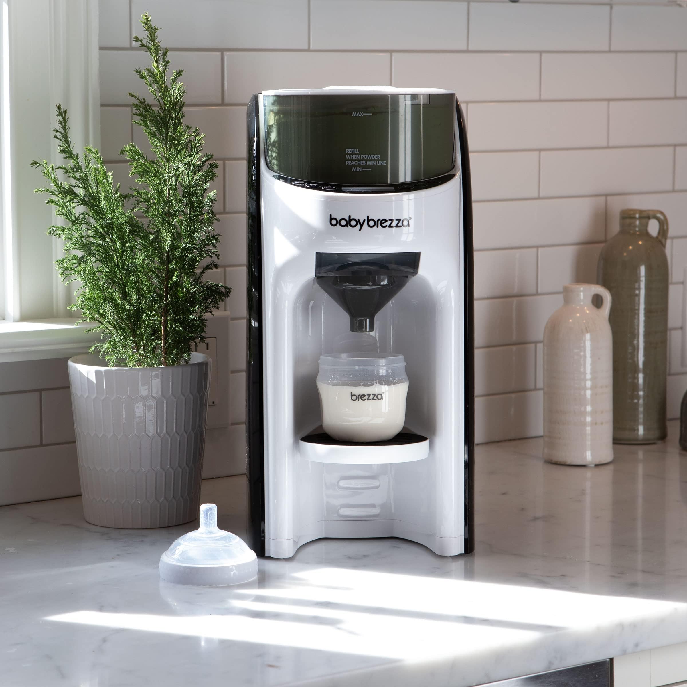 Baby Brezza next to a standard bottle illustrating size and scale