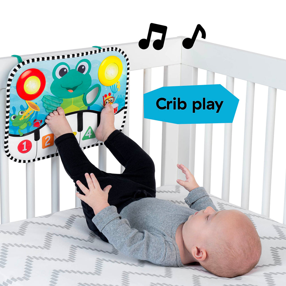 Baby Einstein pad attached to crib demonstrating hands-free kick activation benefit