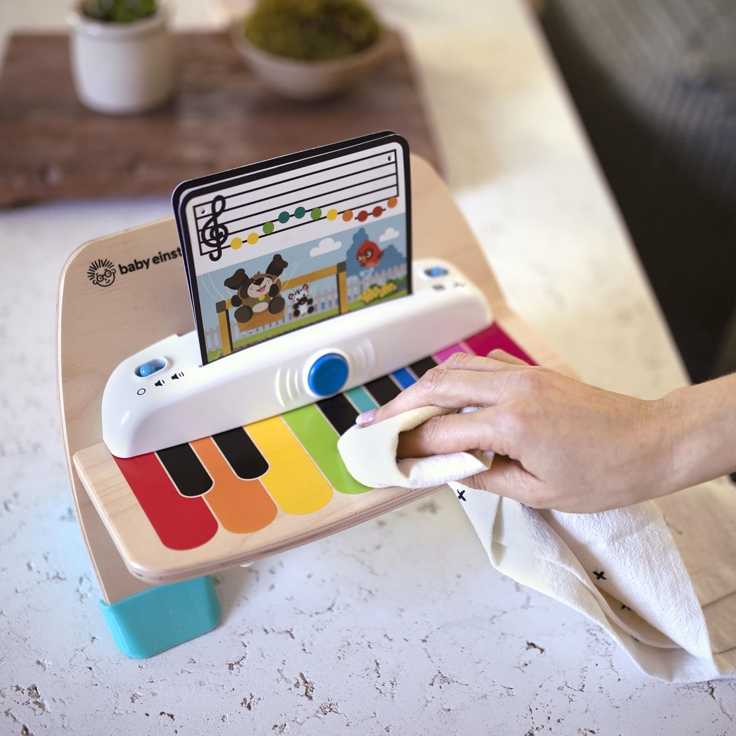 Baby Einstein piano on bench in a living room lifestyle scene encouraging shared family play benefit