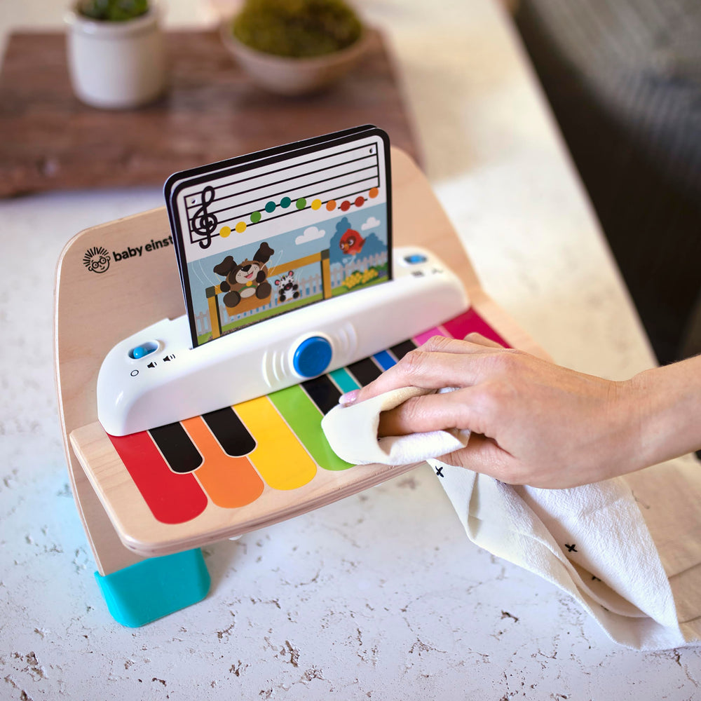 Baby Einstein piano on bench in a living room lifestyle scene encouraging shared family play benefit