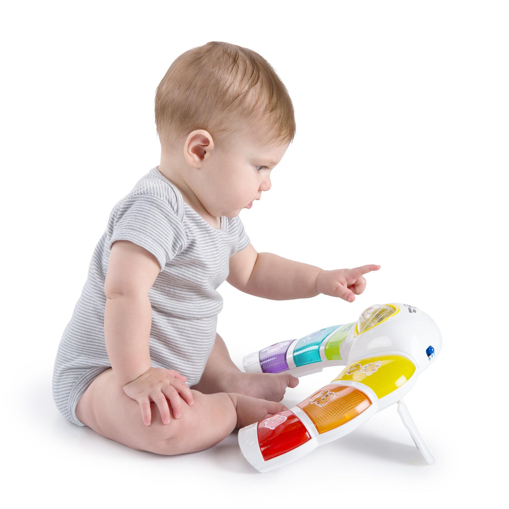 Baby Einstein next to blocks for scale, shows compact portable size