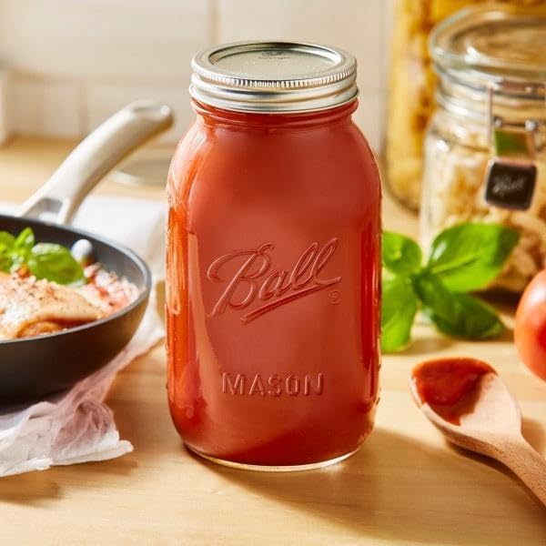 Ball jar next to measuring cup showing scale and 32 ounce capacity