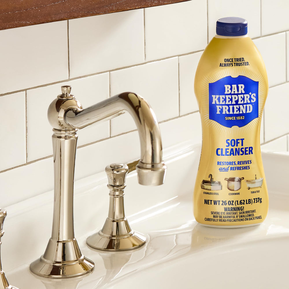 Bar Keepers Friend bottles beside a standard sink to show 26 oz size and scale