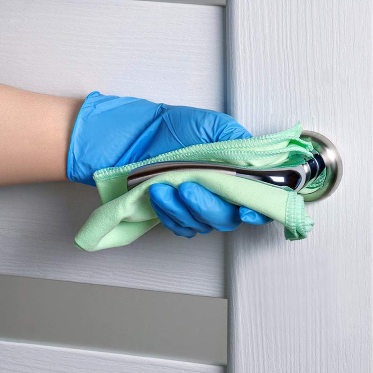 Basic Medical glove next to hand for scale showing accurate medium sizing