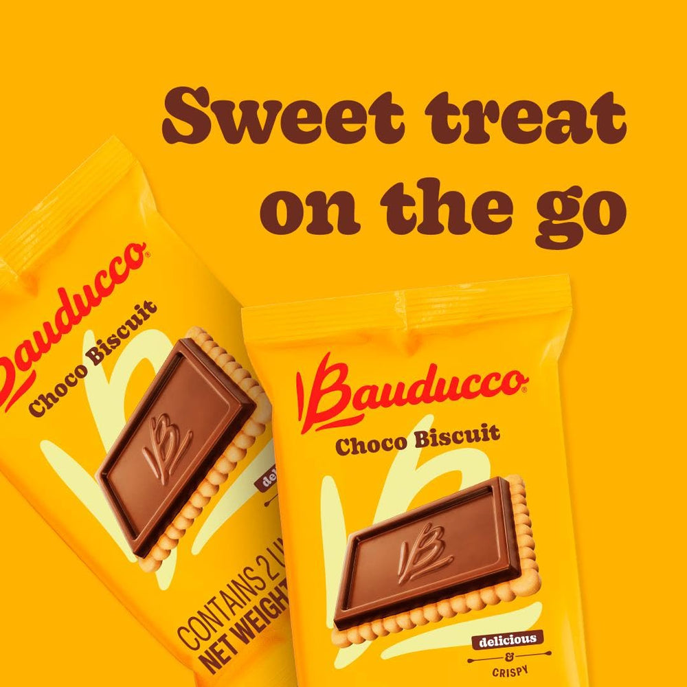 Bauducco cookie in hand beside ruler to show size and portability for on-the-go snacking