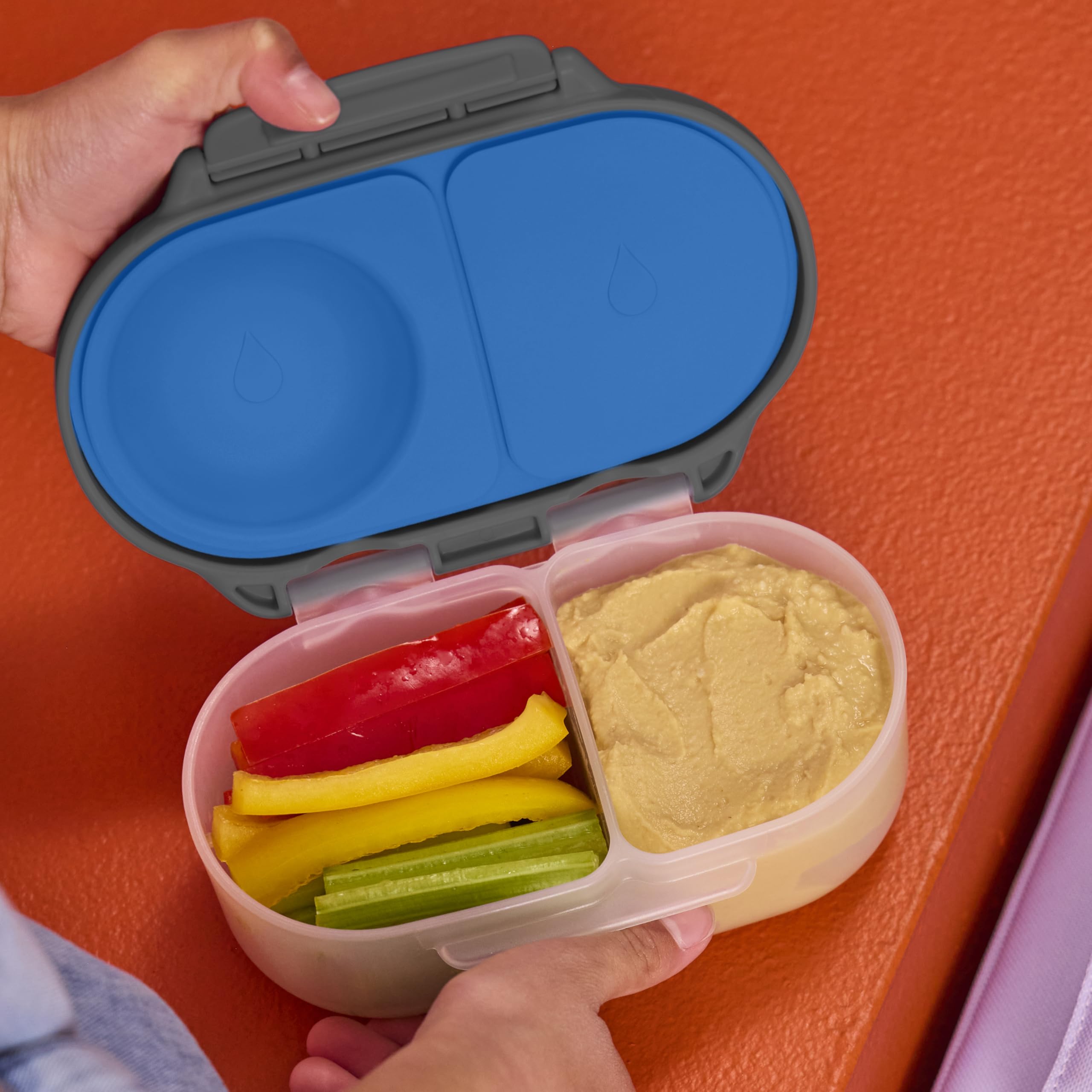 b.box large grip clips being opened by a child’s hand to promote independent use