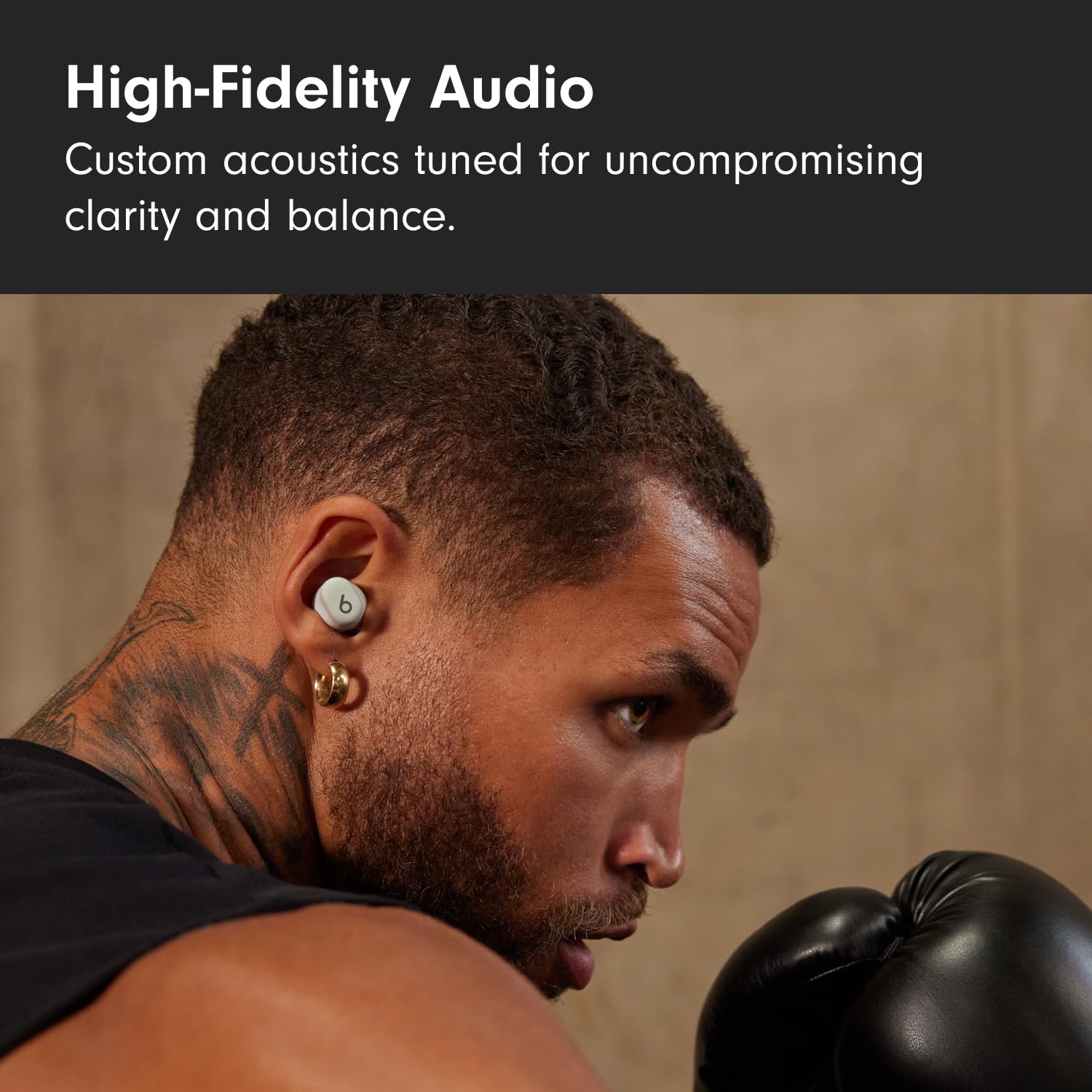Beats Solo Buds earbud close-up detailing dual-layer driver and sound clarity benefit