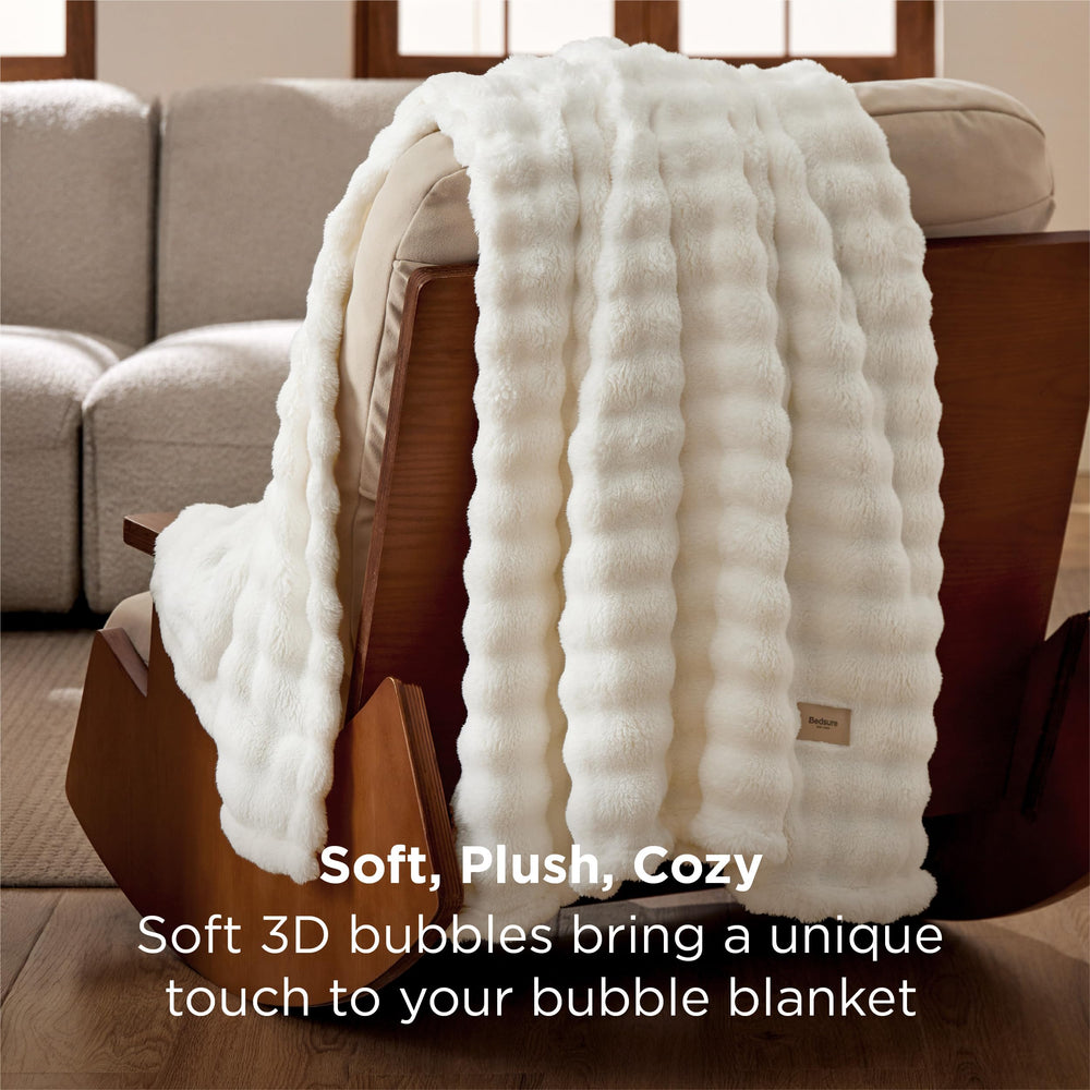 Bedsure folded blanket beside a book to show 50x60 size and easy storage benefit