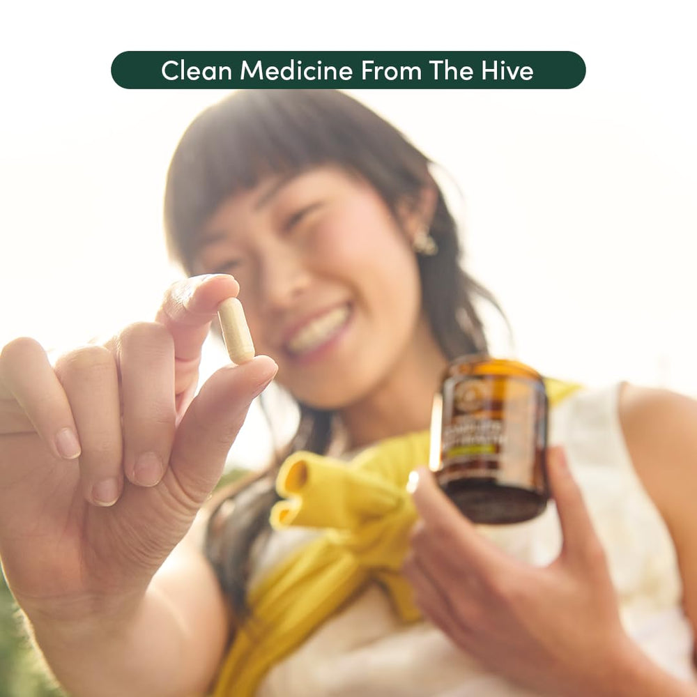 Beekeeper's Naturals user taking a capsule illustrating easy daily use