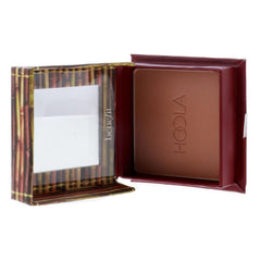 Benefit Hoola in-use as brush applies warm matte bronze for natural contour
