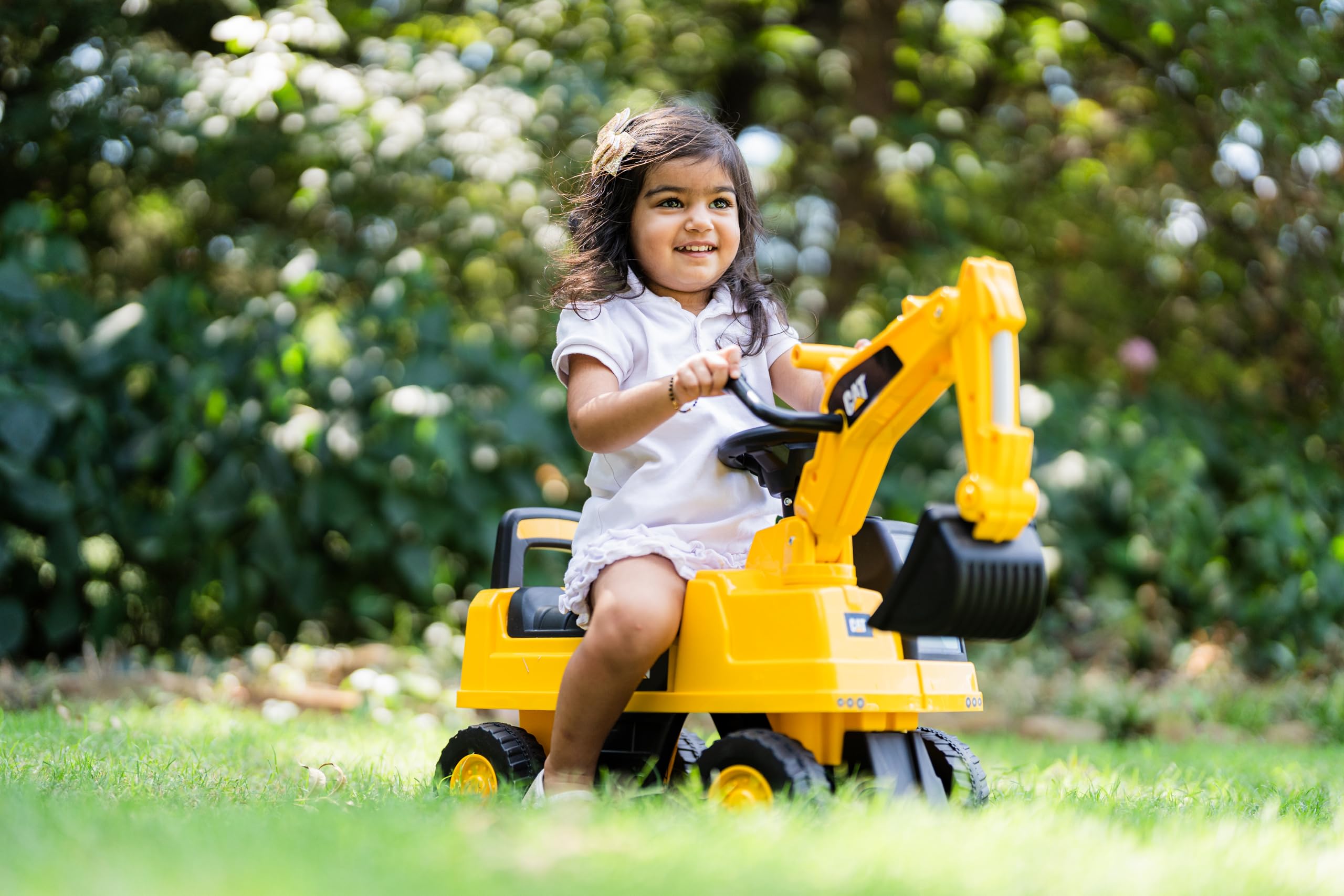 Best Ride On Cars CAT in backyard lifestyle scene showing outdoor active play