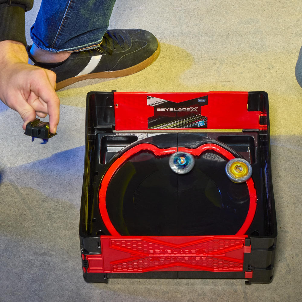Beyblade stadium next to backpack showing transport convenience