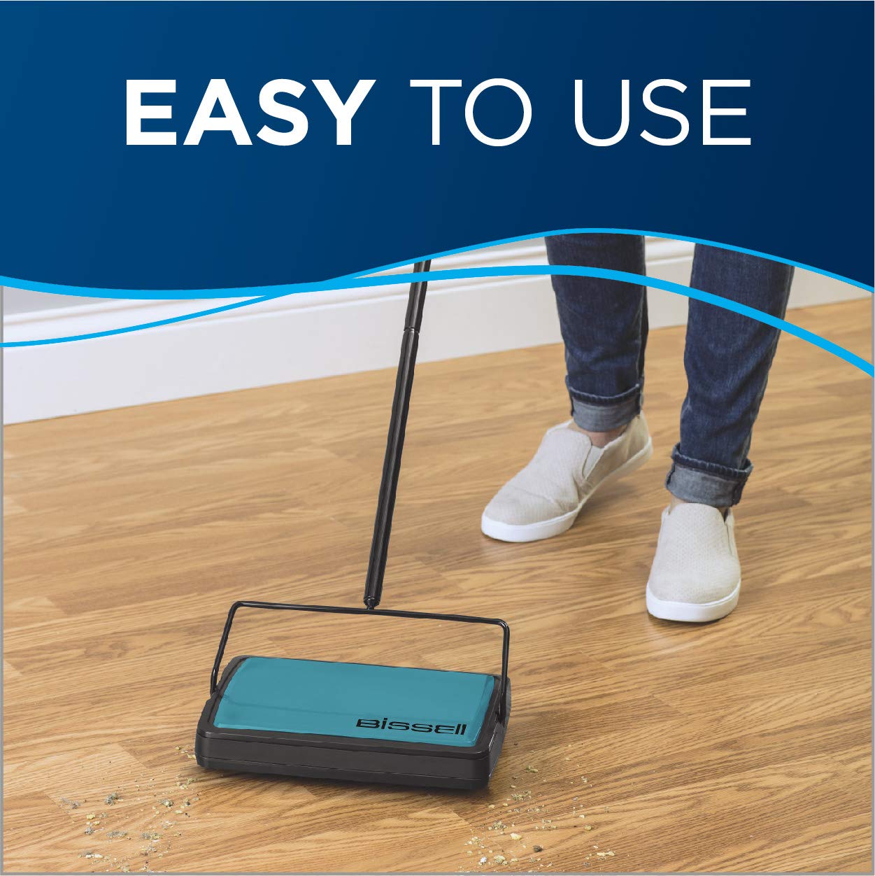 Bissell sweeper bottom bins open to empty debris cleanly, demonstrating easy disposal