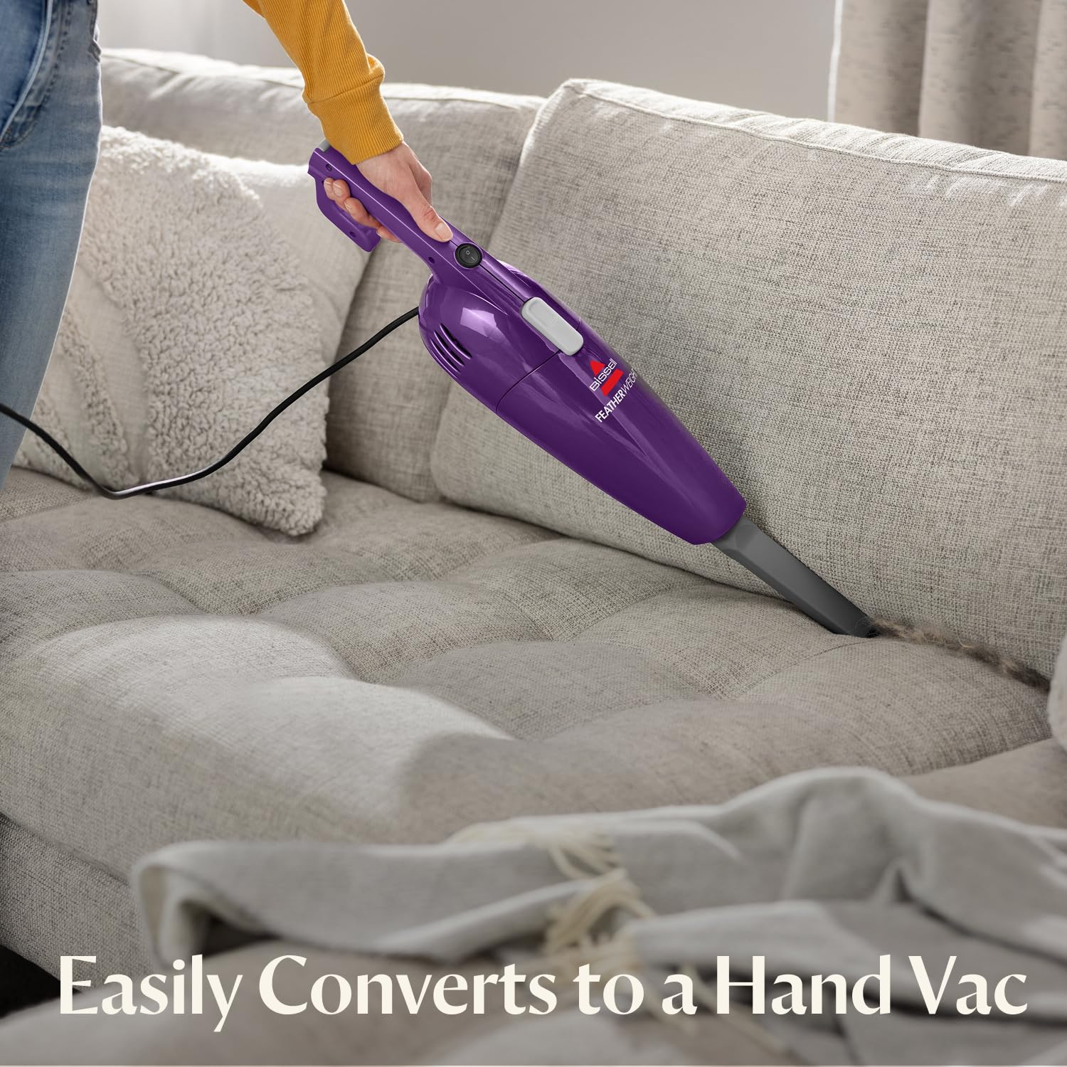 Bissell FeatherWeight in hand-vac mode cleaning sofa cushions for quick pet hair pickup
