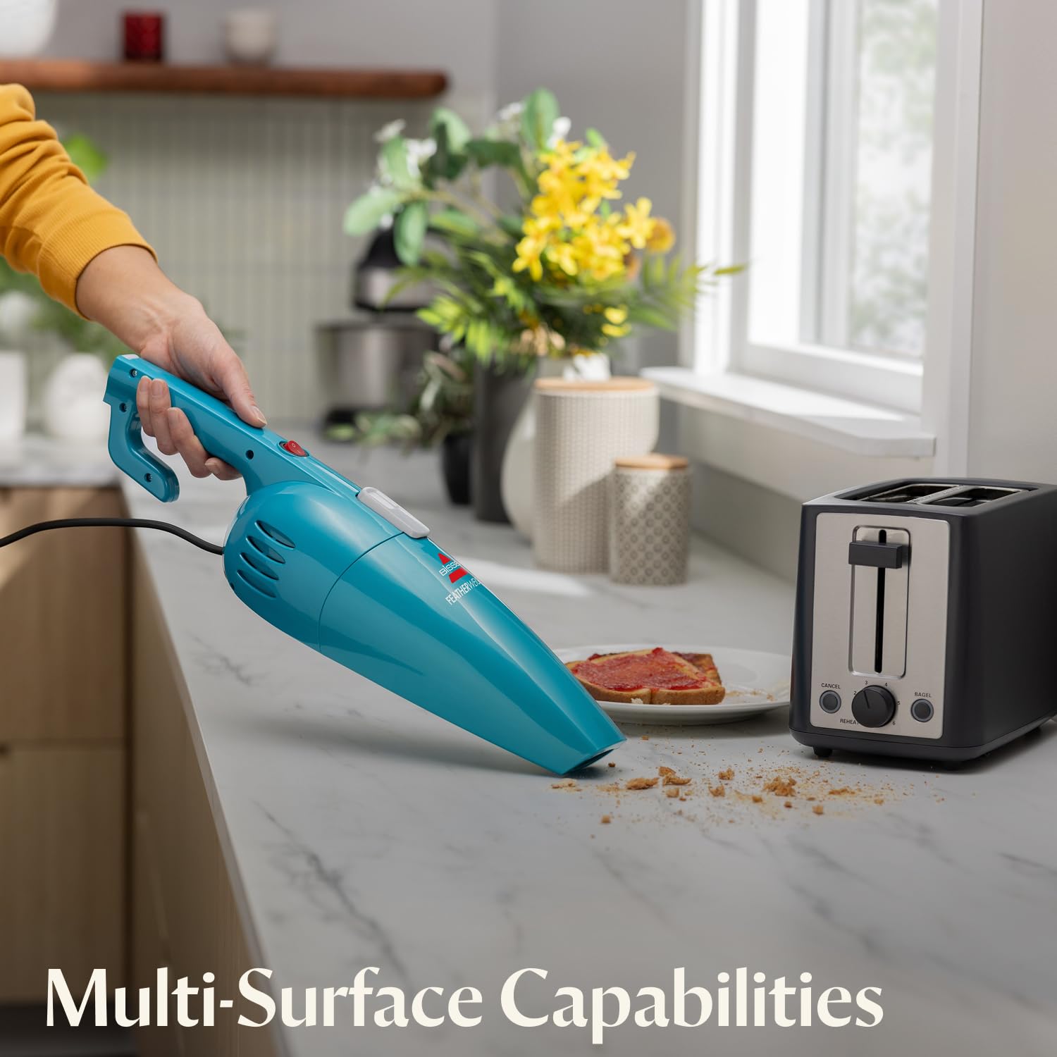 Bissell Featherweight beside a water bottle to show lightweight portability benefit
