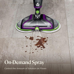 BISSELL in use on sealed hardwood removing a pet mess for restored floor shine