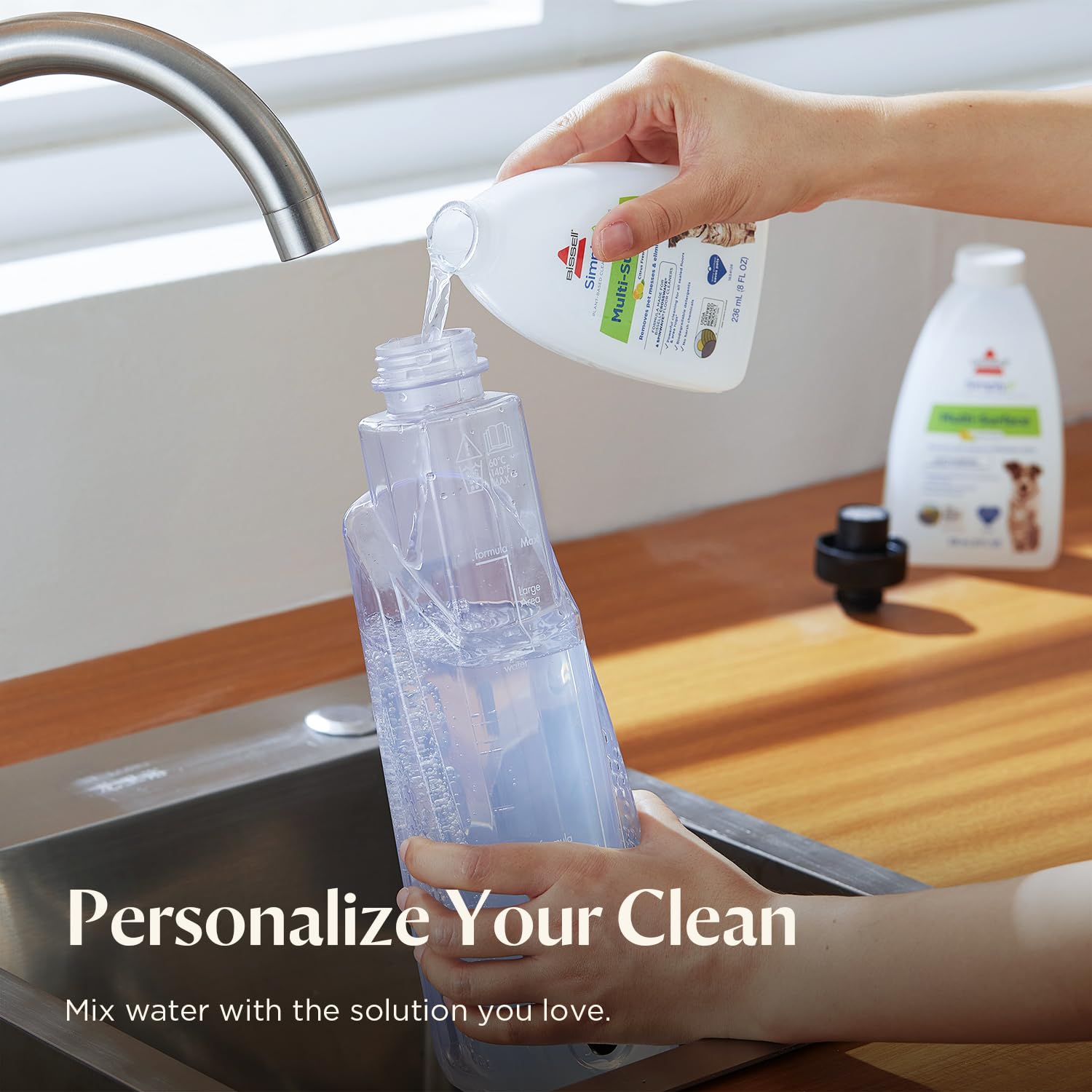 BISSELL included accessories laid out: reusable pads and trial cleaning solutions