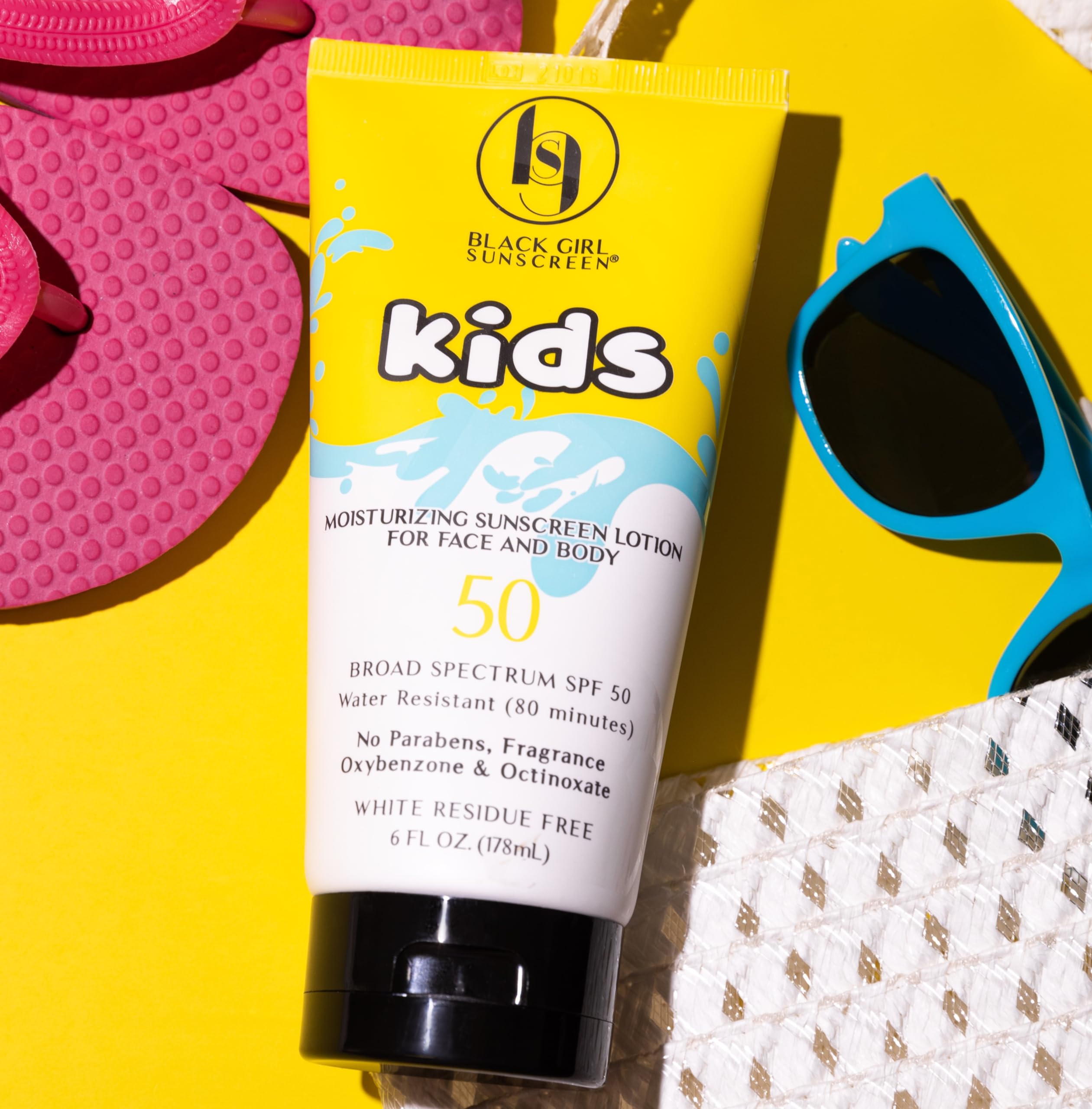 Black Girl Sunscreen kids bottle held in hand showing convenient size for travel