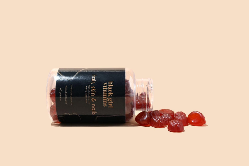 Black Girl Vitamins on bathroom counter beside skincare for daily beauty routine