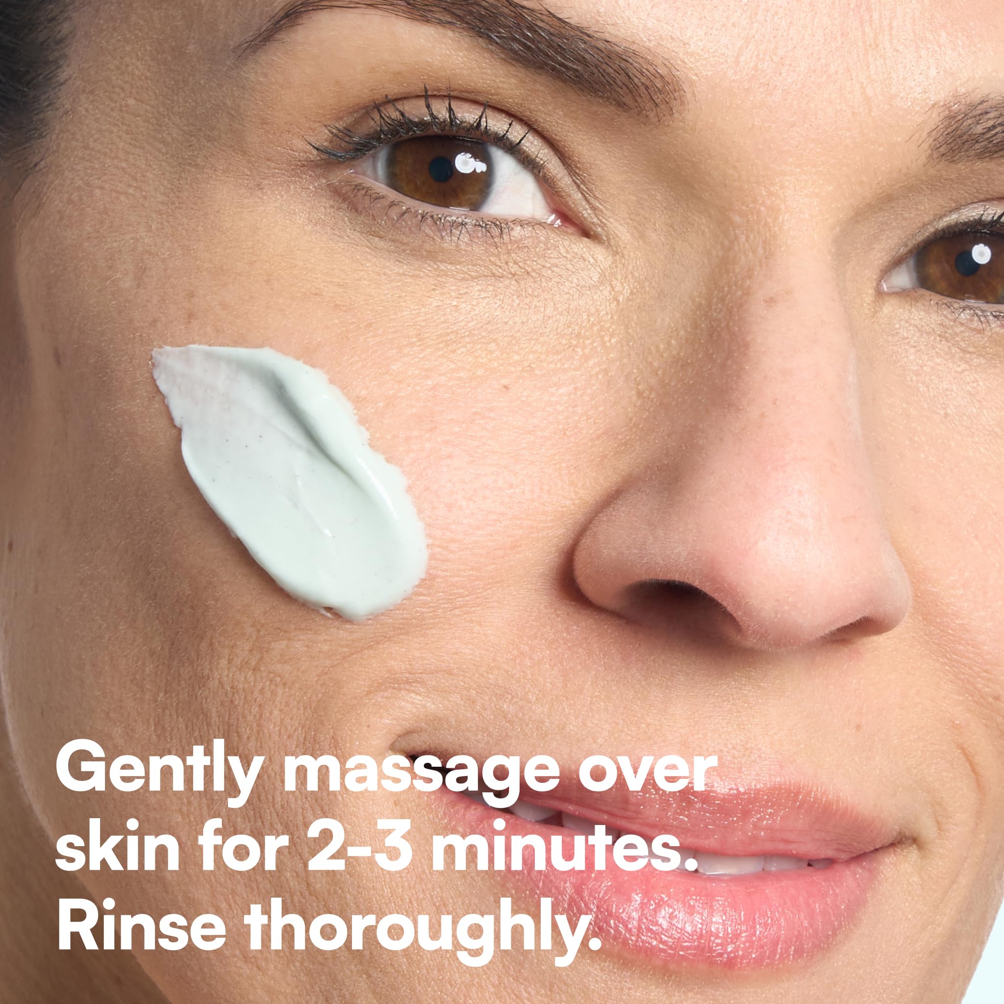 Bliss applying scrub to face during routine, depicts gentle massage benefit