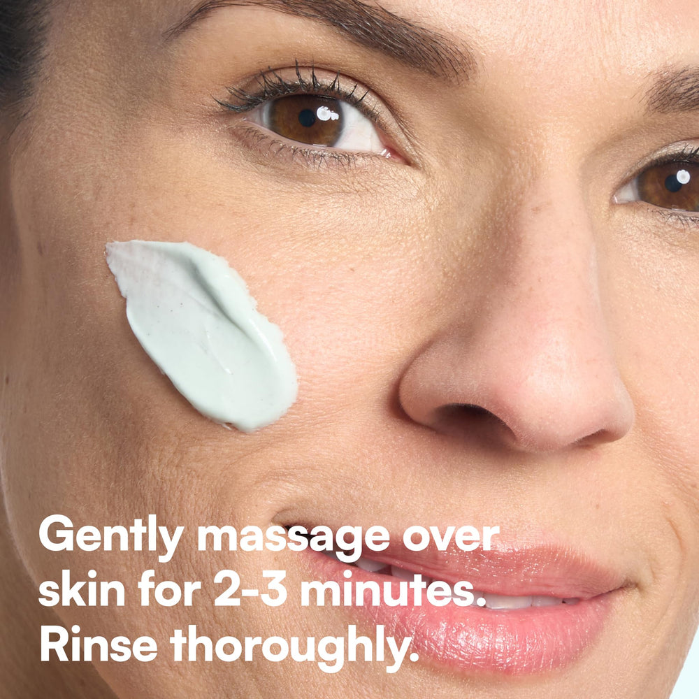 Bliss applying scrub to face during routine, depicts gentle massage benefit
