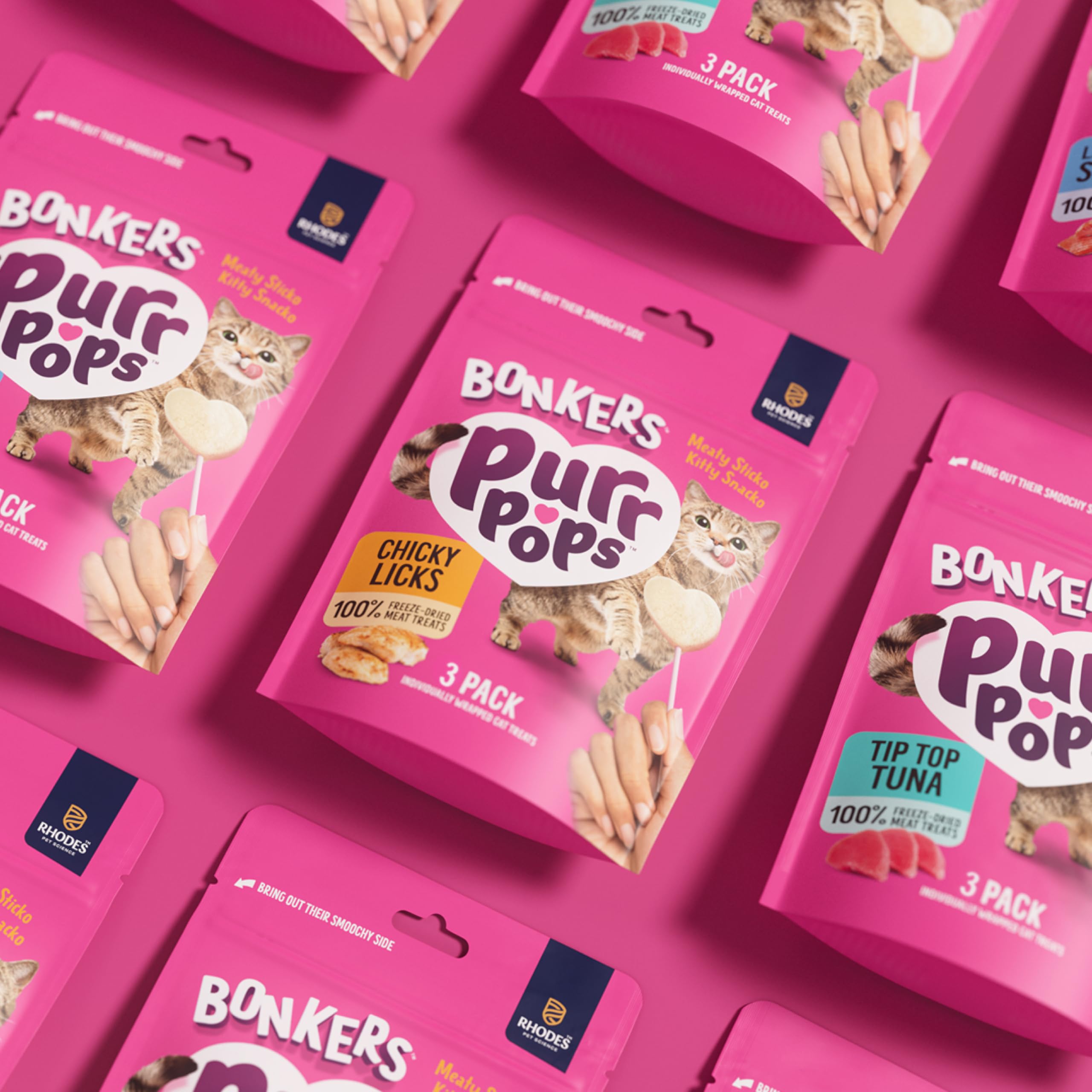 Bonkers Purrpops held in cat paw demonstrating engaging treat interaction