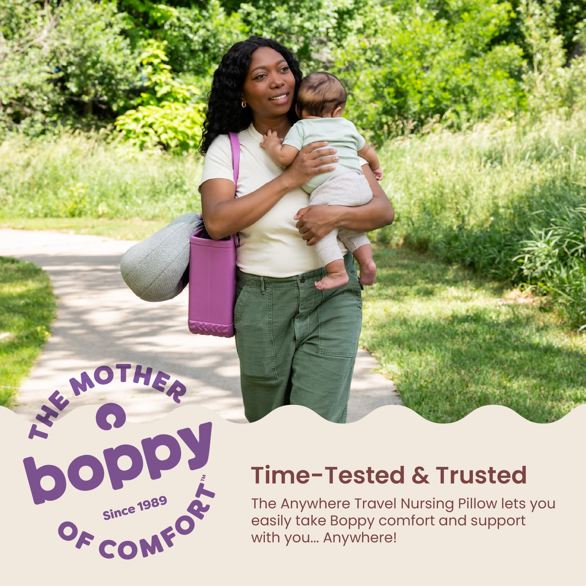 Boppy Anywhere beside adult hand showing compact scale and lightweight design