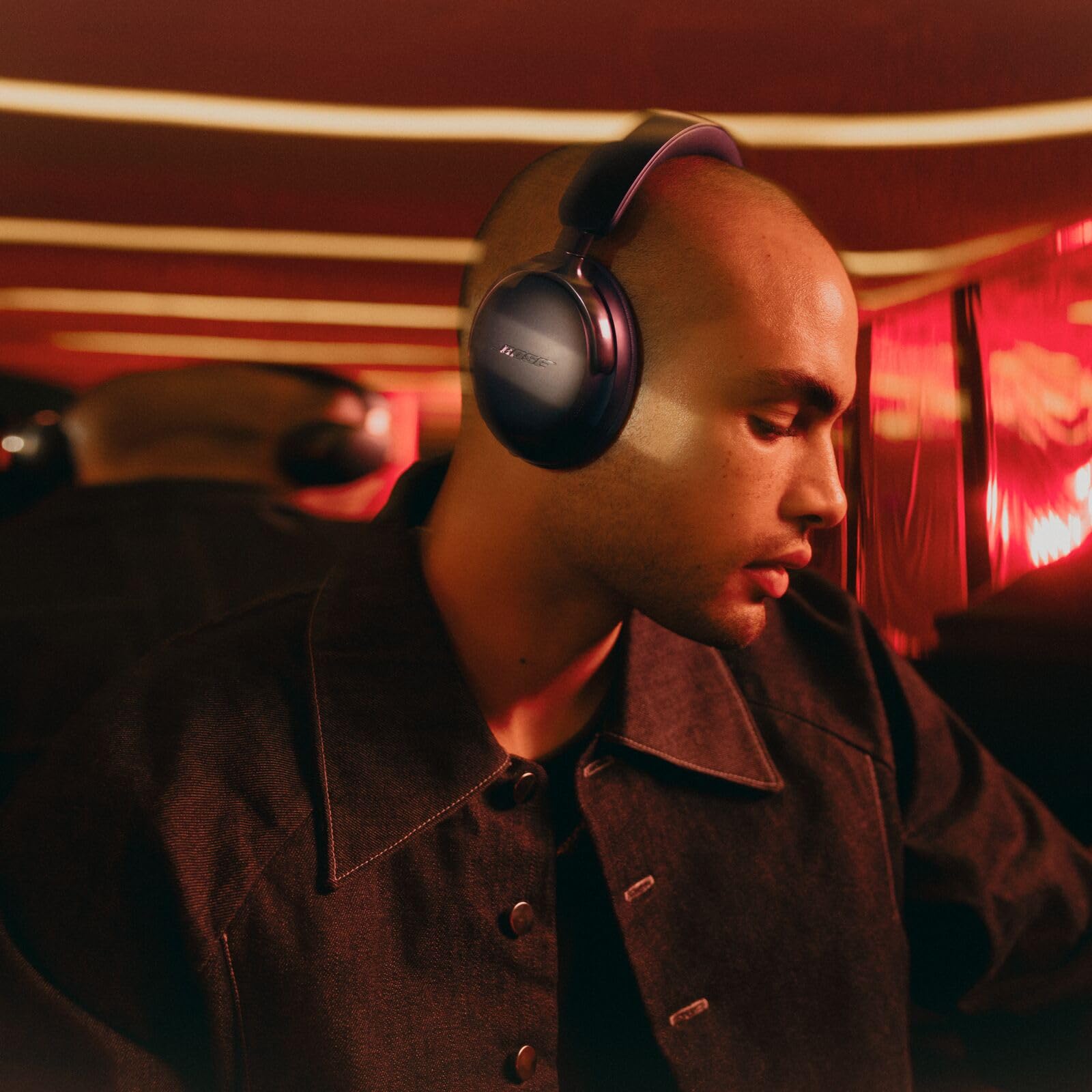 Bose QuietComfort Ultra headband detail showing metal arms and even pressure distribution benefit