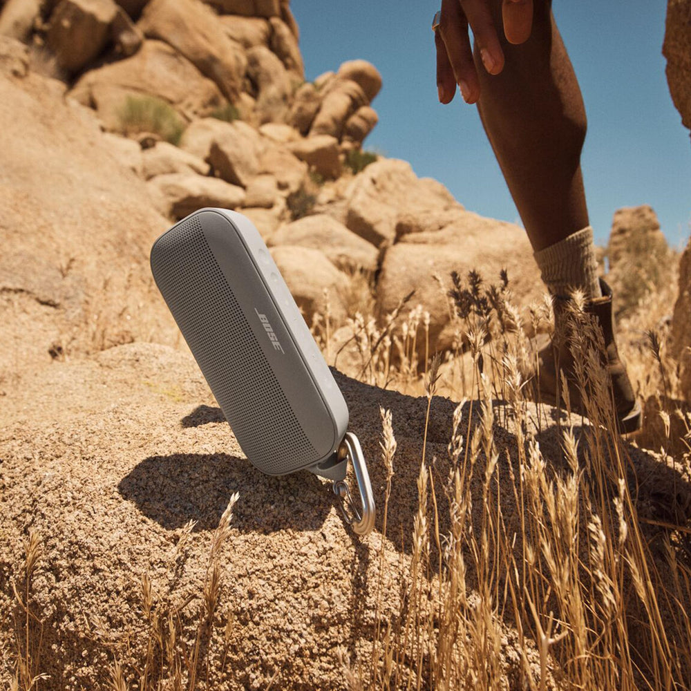 Bose SoundLink Flex attached to backpack, rugged speaker built for outdoor adventures