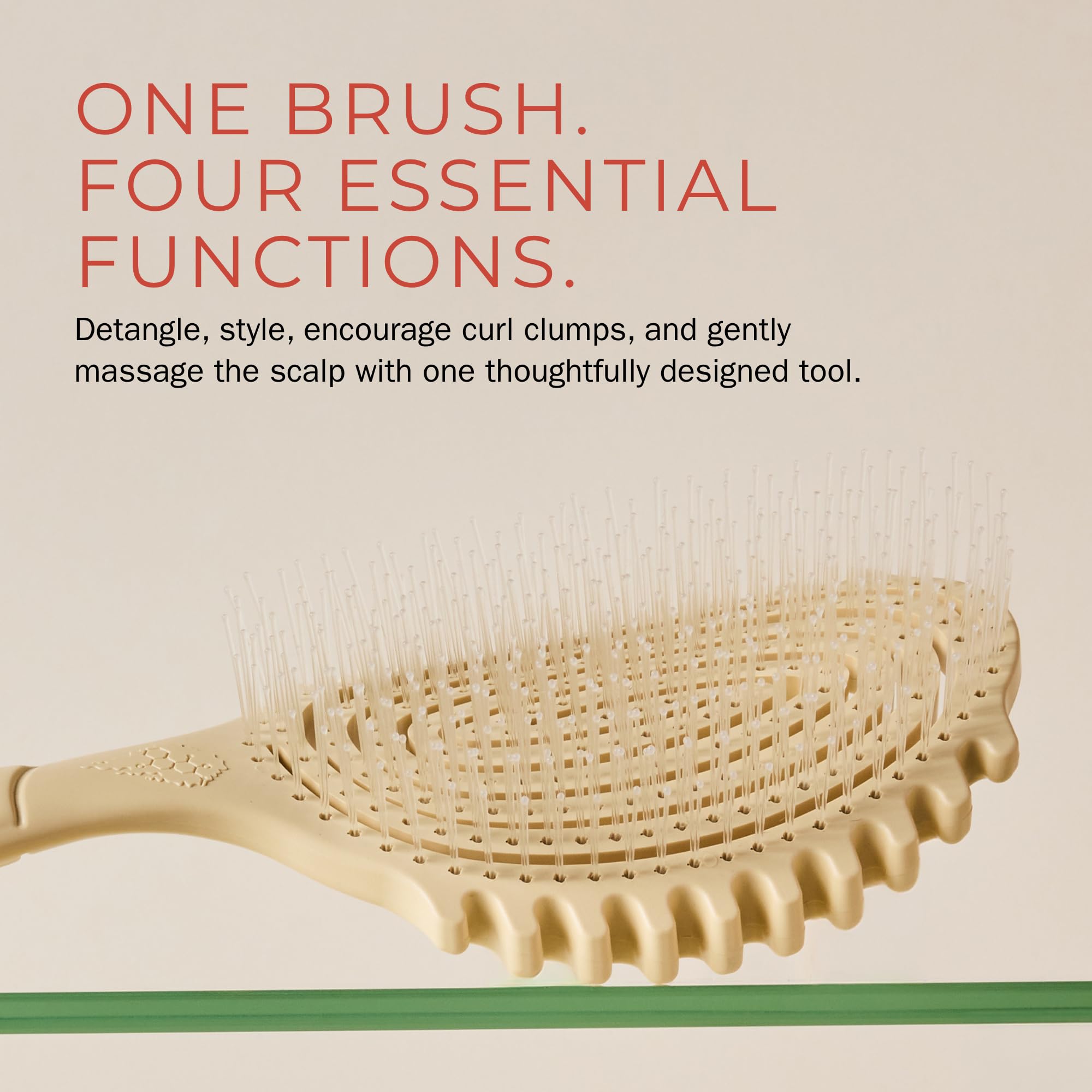 Bounce Curl brush held in hand to show scale and easy handling benefit