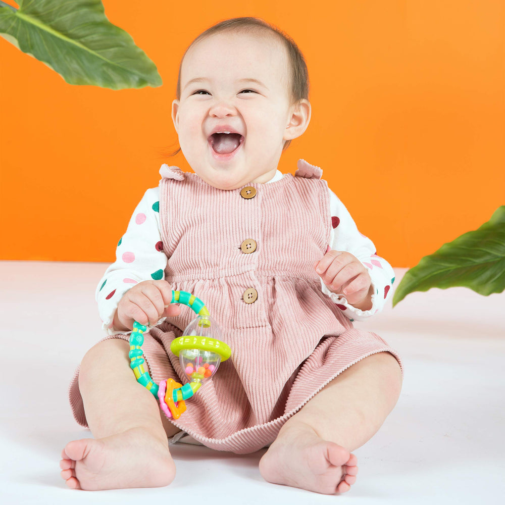 Bright Starts License to Drool key-ring teether shown in hand for soothing teething