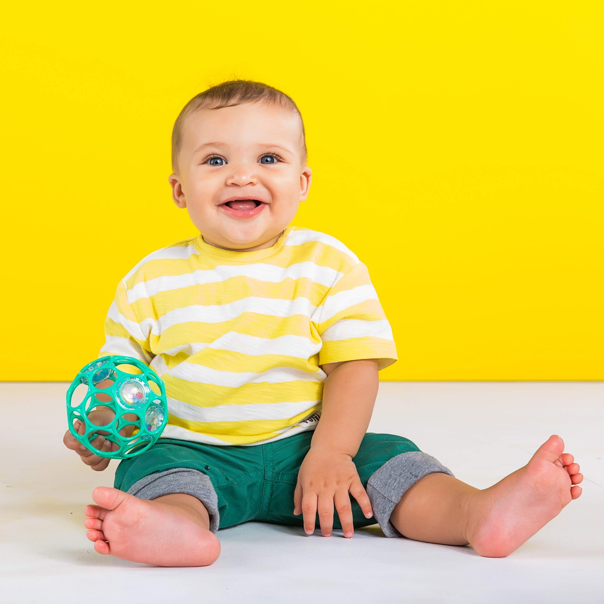 Bright Starts Oball rattle close-up showing flexible holes for easy baby grasping