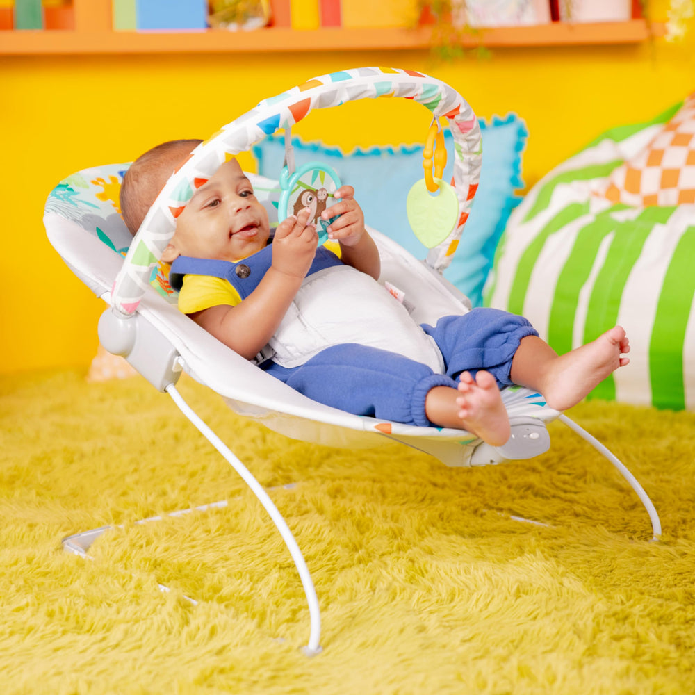 Bright Starts side profile of bouncer demonstrating shallow footprint and gentle recline for baby