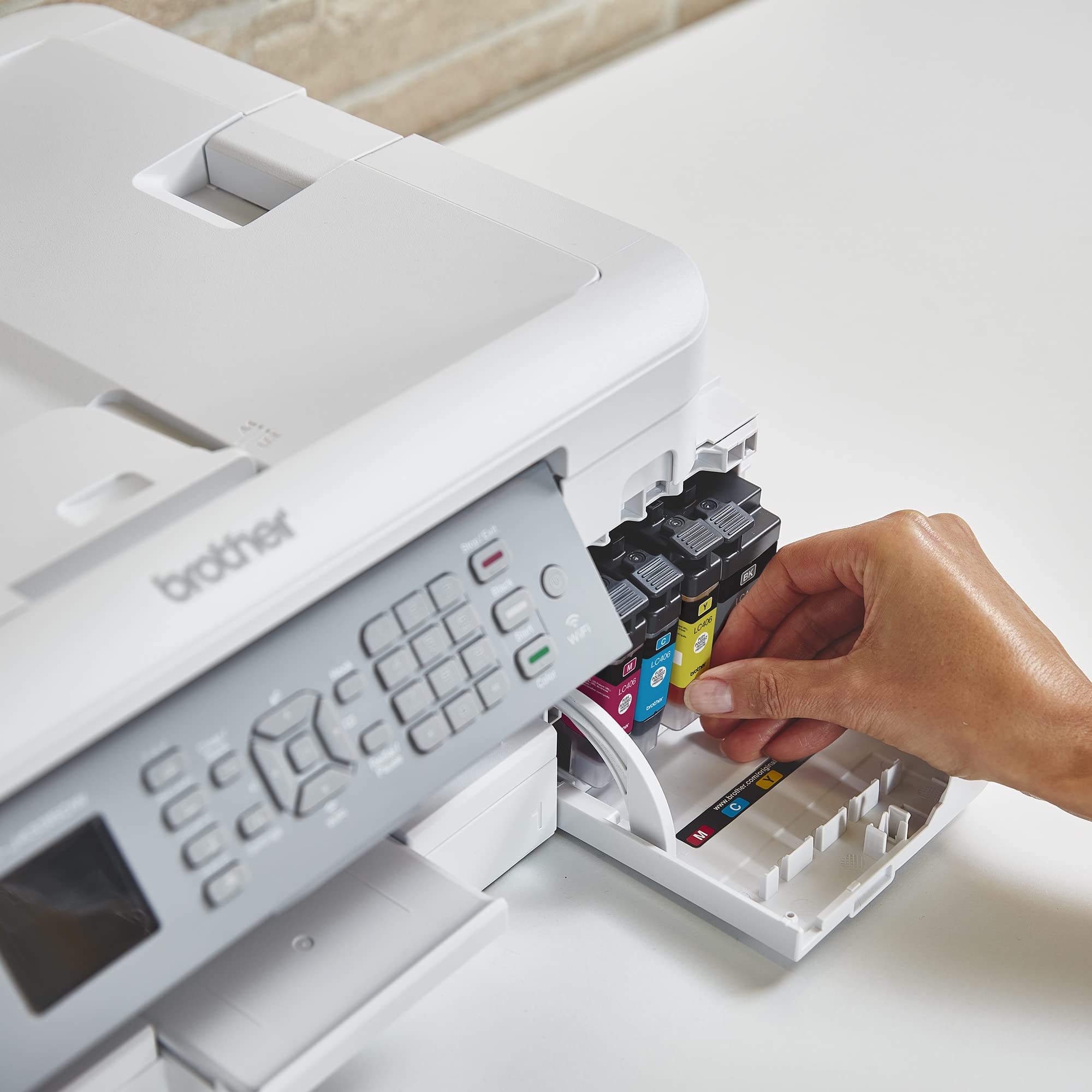 LC406BK cartridge beside a ruler showing Brother size and easy handling