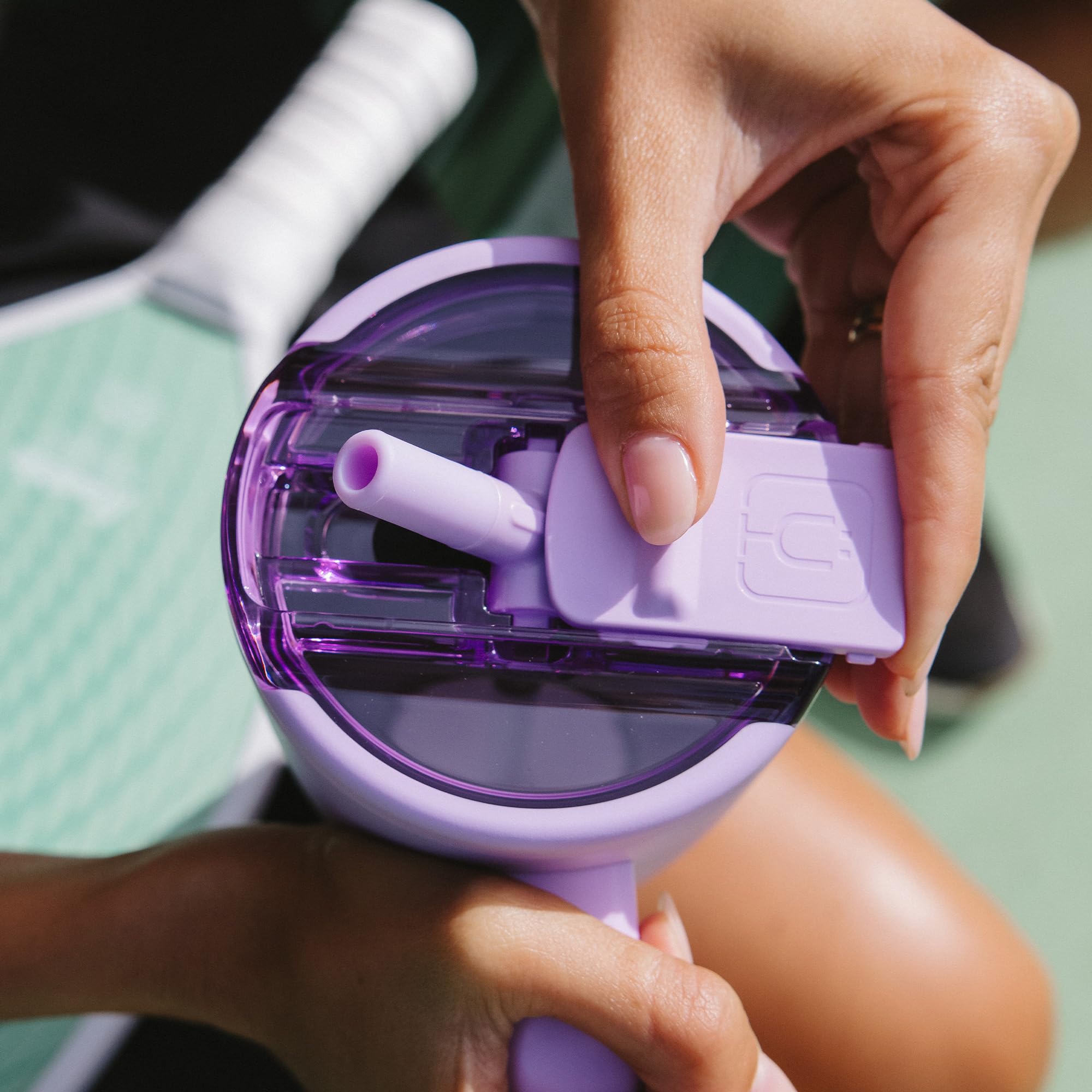 BrüMate Era Flip seated in car cup holder demonstrating travel-friendly design