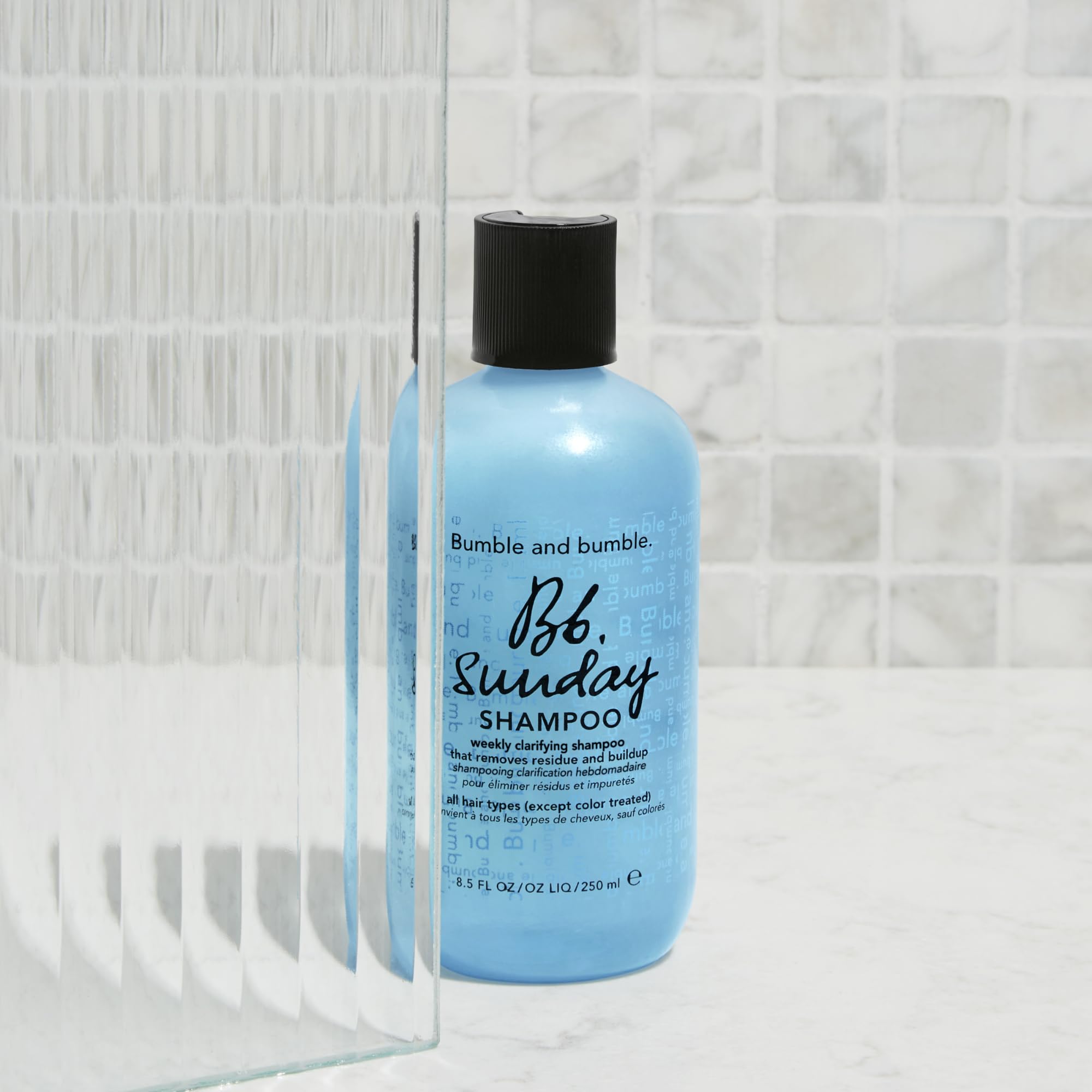 Bumble and bumble bottle on bathroom shelf styled to show everyday use and aesthetic