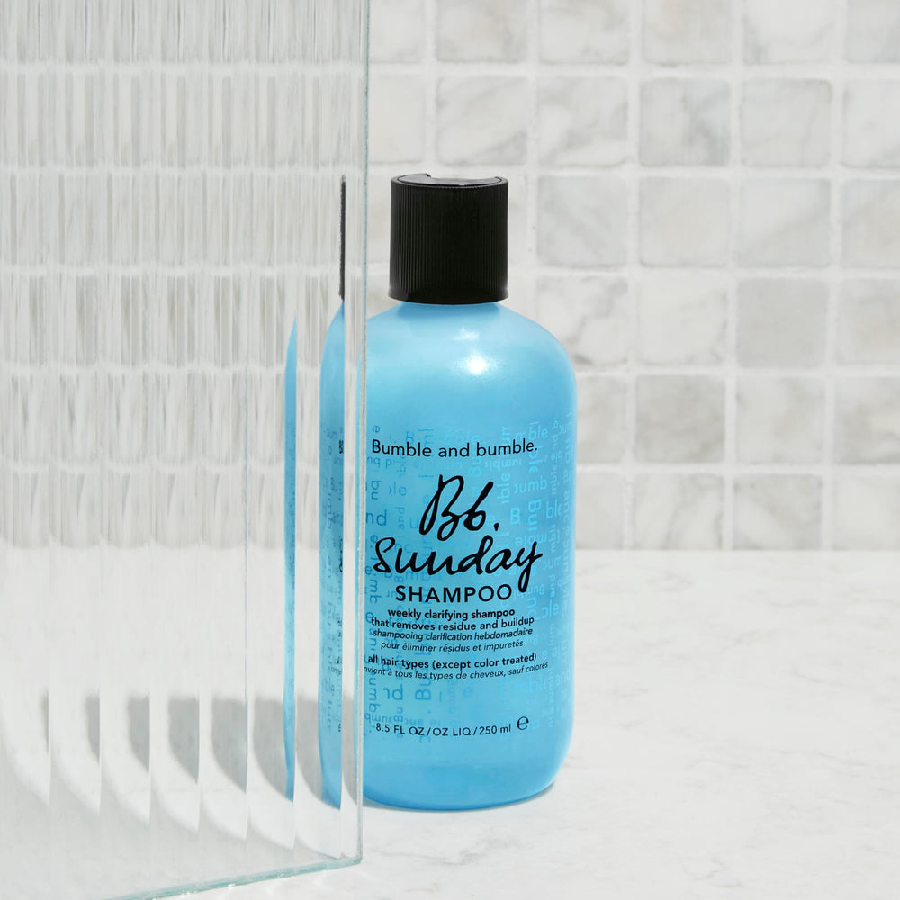 Bumble and bumble bottle on bathroom shelf styled to show everyday use and aesthetic