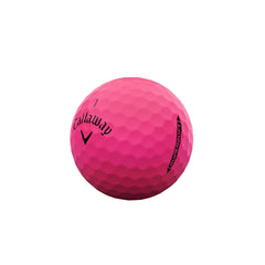 Hand holding a Callaway Supersoft pink ball to show size and low-compression feel for golfers
