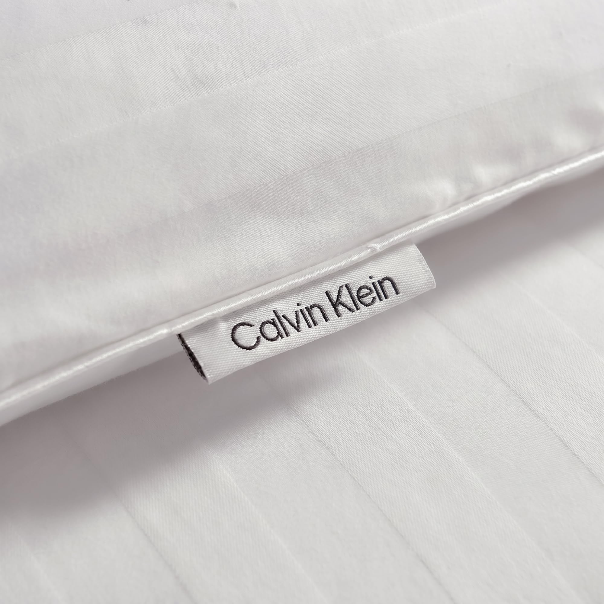 Calvin Klein folded compressed comforter showing vacuum-sealed shipping and compact storage benefit